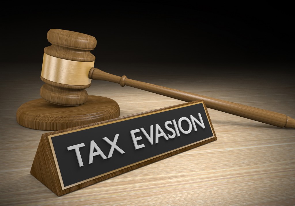 3D render of a court gavel and a sign with the words tax evasion, representing avoidance of paying taxes.