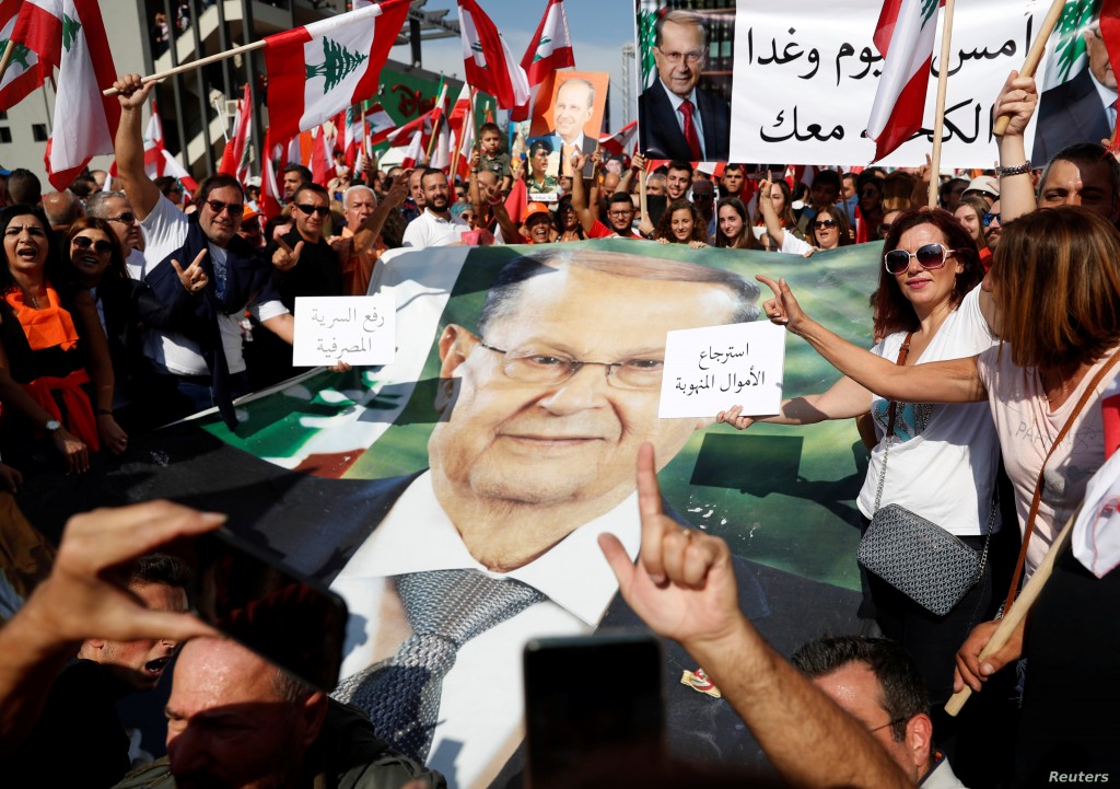 Supporters of Lebanon's President Michel Aoun hold his poster during a rally in Baabda near Beirut, Lebanon, November 3, 2019. REUTERS/Goran Tomasevic