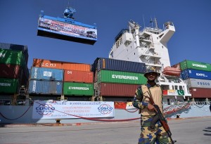 A Pakistani Naval personnel stands guard beside a ship carrying containers during the opening of a trade project in Gwadar port, some 700 kms west of Karachi on November 13, 2016. Pakistan's Prime Minister Nawaz Sharif on November 13 opened a trade route linking the southwestern post of Gwadar to the Chinese city of Kashgar as part of a joint multi-billion-dollar project to jumpstart economic growth in the South Asian country.  / AFP PHOTO / AAMIR QURESHI