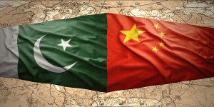 Waving Pakistani and Chinese flags on the of the political map of the world