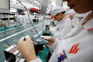 A manufacturer works at an assembly line of Vingroup's Vsmart phone in Hai Phong