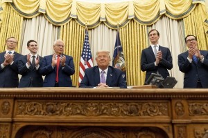 President Donald Trump, accompanied by F=from left, U.S. special envoy for Iran Brian Hook, Avraham Berkowitz, Assistant to the President and Special Representative for International Negotiations, U.S. Ambassador to Israel David Friedman, President Donald Trump's White House senior adviser Jared Kushner, and Treasury Secretary Steven Mnuchin, applaud in the Oval Office at the White House, Wednesday, Aug. 12, 2020, in Washington. Trump said on Thursday that the United Arab Emirates and Israel have agreed to establish full diplomatic ties as part of a deal to halt the annexation of occupied land sought by the Palestinians for their future state. (AP Photo/Andrew Harnik)