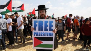 A demonstrator takes part in a rally of Israeli Arabs calling for the right of return for refugees who fled their homes during the 1948 Arab-Israeli War, near Atlit